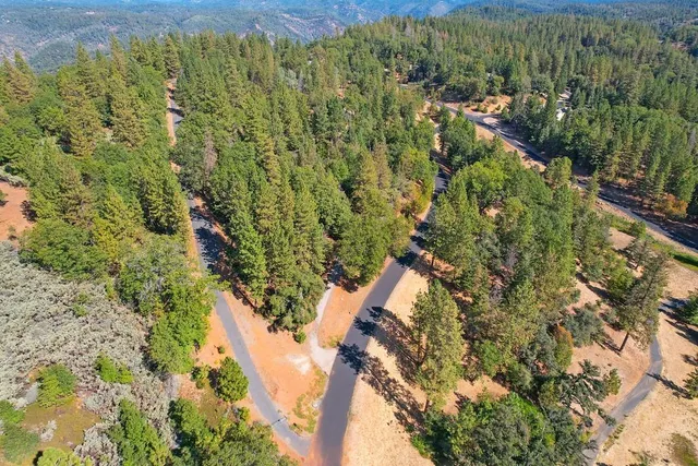 an aerial view of residential houses with green space