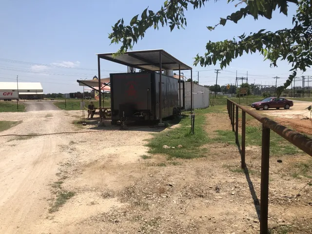 a view of backyard with wooden fence