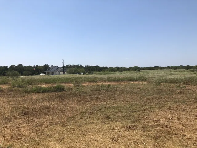 a view of a lake with a yard