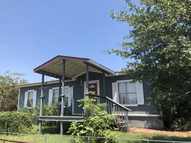 a swimming pool with outdoor seating and yard