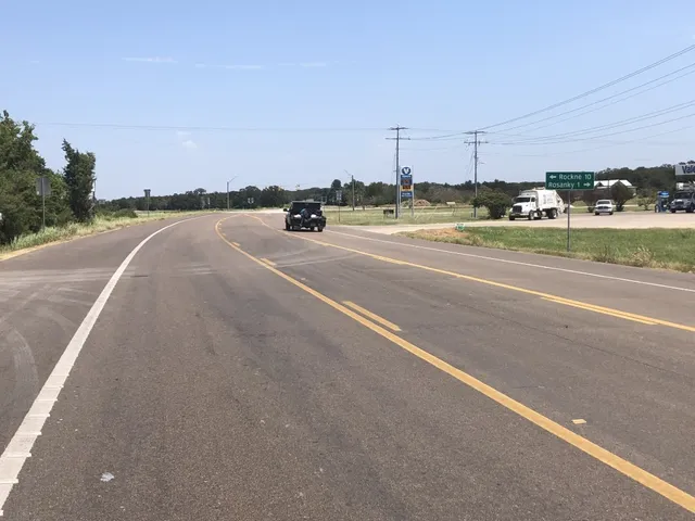 a view of a house with a yard and lake view