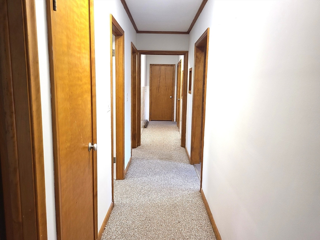 159 Lake Street, Unit 1 Weymouth, MA 02189 - Photo 19 of 21 a view of a hallway with wooden floor