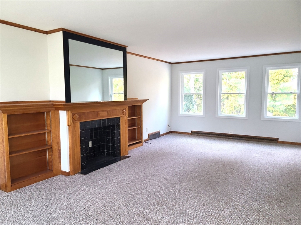 159 Lake Street, Unit 1 Weymouth, MA 02189 - Photo 2 of 21 an empty room with windows and fireplace
