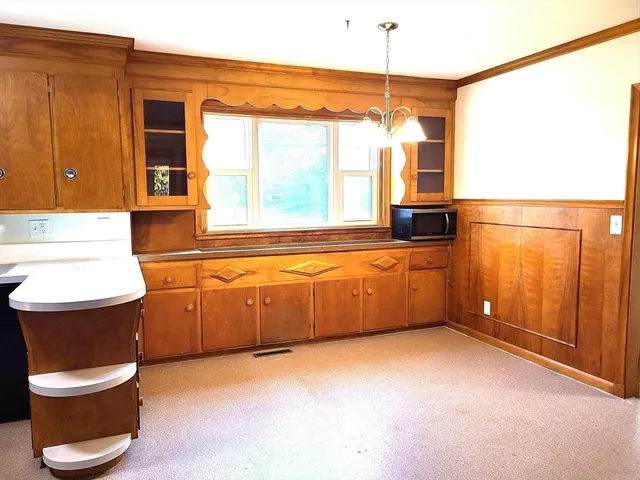 a kitchen with stainless steel appliances granite countertop a refrigerator a sink and a stove