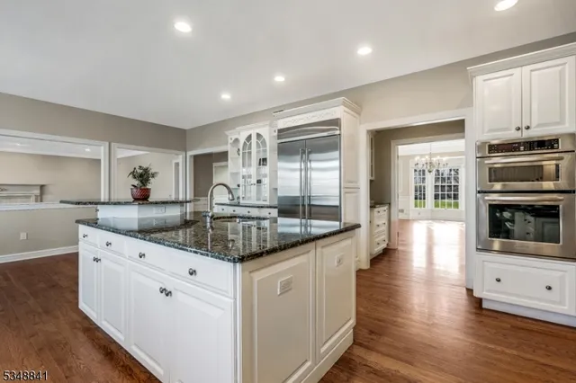 a kitchen with granite countertop a stove and a sink