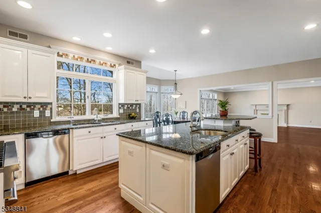 a kitchen with stainless steel appliances granite countertop a sink and stove top oven