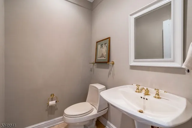 a bathroom with a sink a toilet and mirror