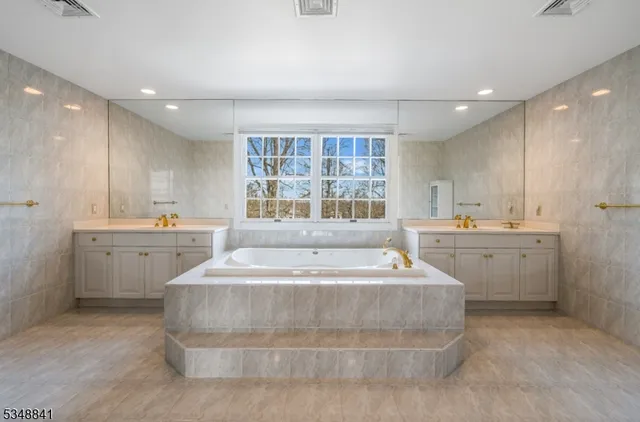 a large white kitchen with a white countertops and cabinets