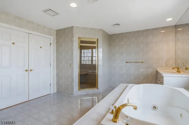 a bathroom with a tub and shower