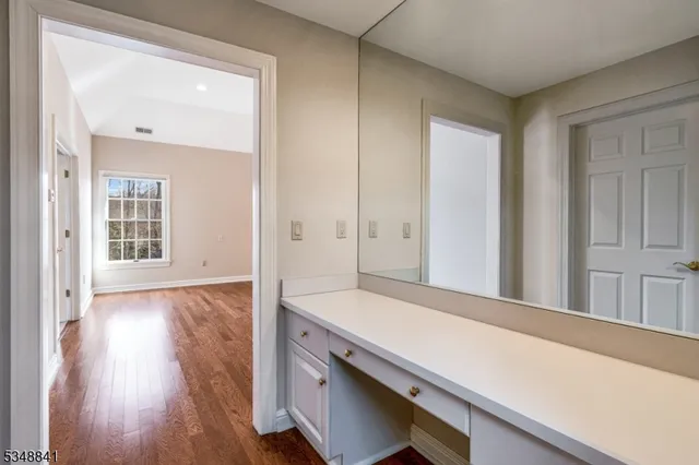 wooden floor with a bench in a room