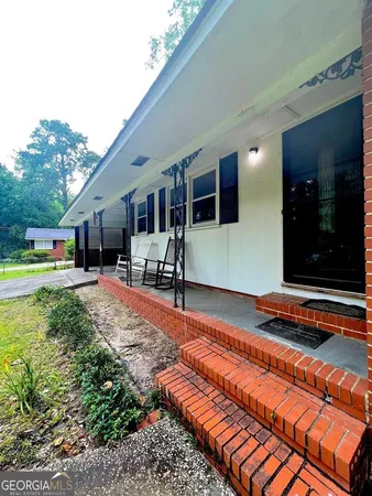 a house with swimming pool in front of it