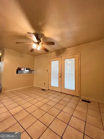 a view of a livingroom with a chandelier fan and fire place