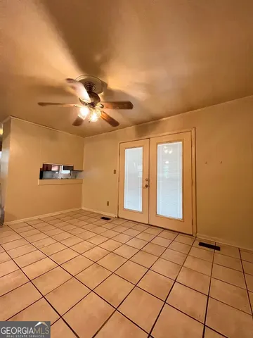 a view of a livingroom with a chandelier fan and fire place