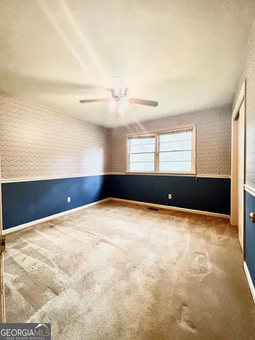 a view of an empty room with windows