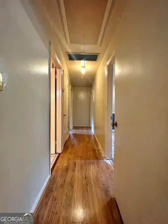 a view of hallway with wooden floor