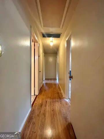 a view of hallway with wooden floor