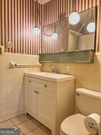 a bathroom with a sink a toilet and mirror