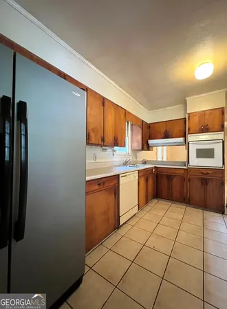 a kitchen with a cabinets a sink and appliances