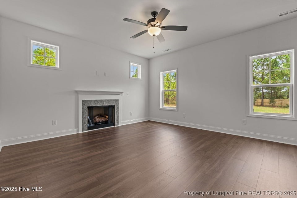 200 Dove Road Cameron, NC 28326 - Photo 11 of 46 a view of an empty room with a window and wooden floor