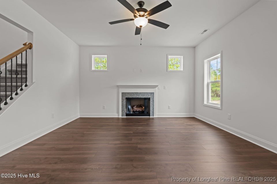 200 Dove Road Cameron, NC 28326 - Photo 13 of 46 a view of an empty room with wooden floor fireplace and a window