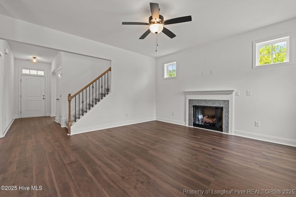 200 Dove Road Cameron, NC 28326 - Photo 14 of 46 a view of empty room with wooden floor and fireplace