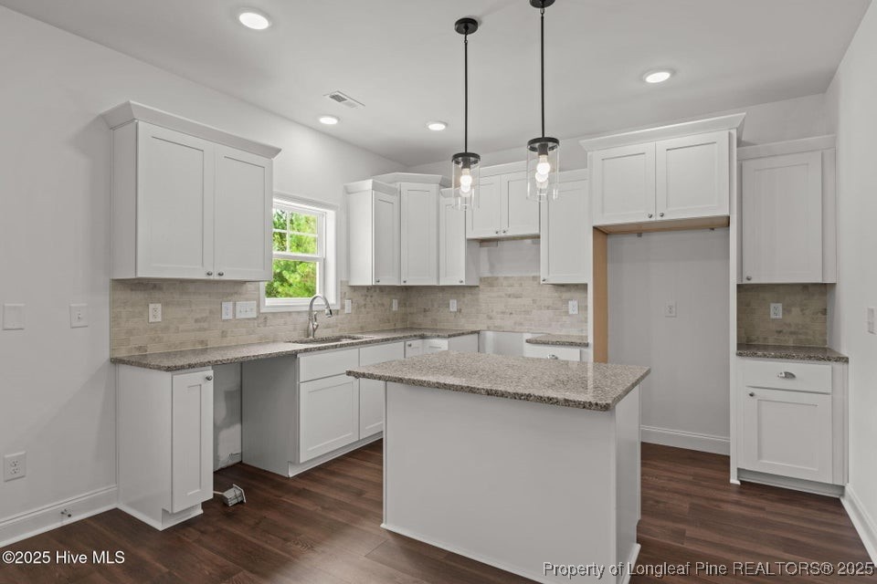 200 Dove Road Cameron, NC 28326 - Photo 16 of 46 a kitchen with stainless steel appliances granite countertop a sink a stove a refrigerator and white cabinets