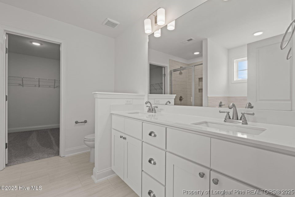 200 Dove Road Cameron, NC 28326 - Photo 33 of 46 a bathroom with double sink and a mirror