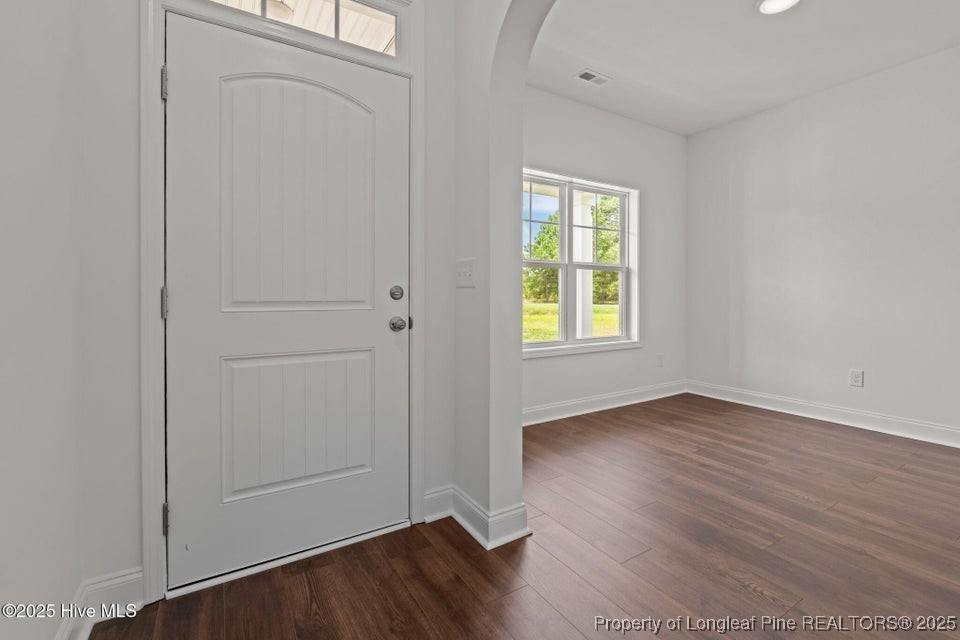 200 Dove Road Cameron, NC 28326 - Photo 7 of 46 an empty room with wooden floor and window