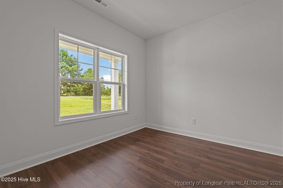 200 Dove Road Cameron, NC 28326 - Photo 8 of 46 a view of an empty room with wooden floor and a window