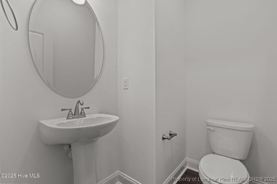 200 Dove Road Cameron, NC 28326 - Photo 10 of 46 a bathroom with a sink a toilet and mirror