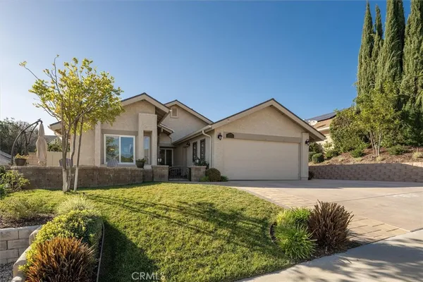 a front view of house with yard and trees