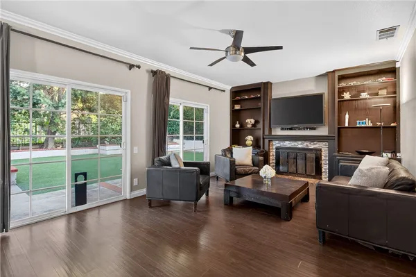 a living room with fireplace furniture and a flat screen tv