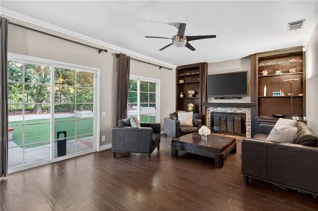 a living room with fireplace furniture and a flat screen tv