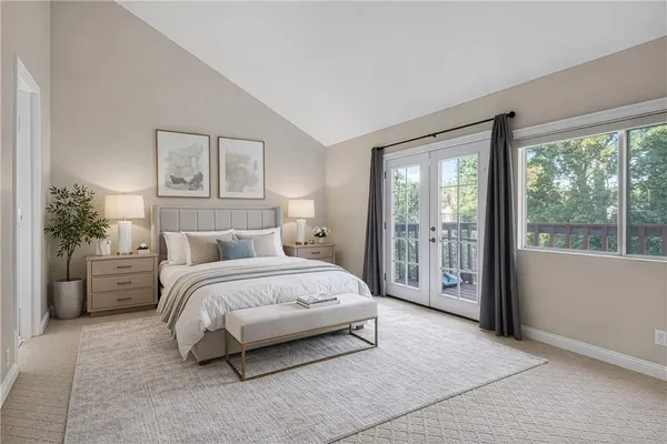 a spacious bedroom with a large bed and a large window