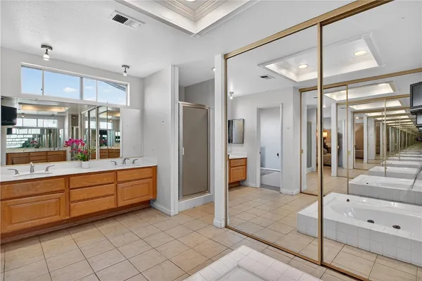 a bathroom with a tub shower and sink