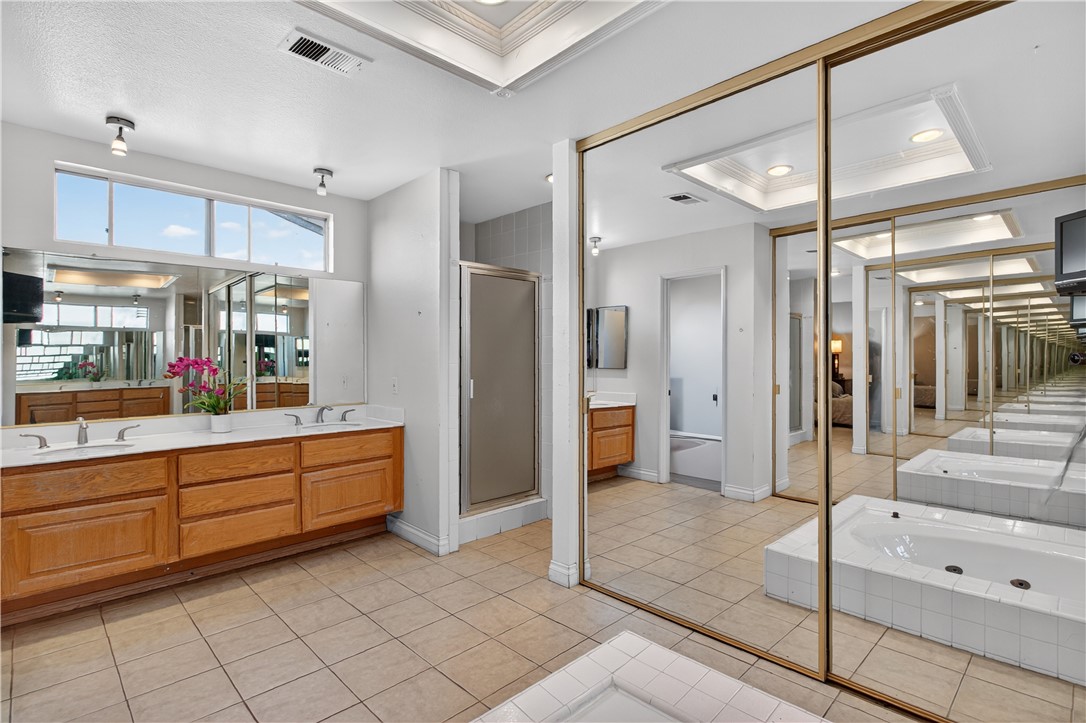 720 Ridgeview Road Anaheim Hills, CA 92807 - Photo 19 of 36 a bathroom with a tub shower and sink