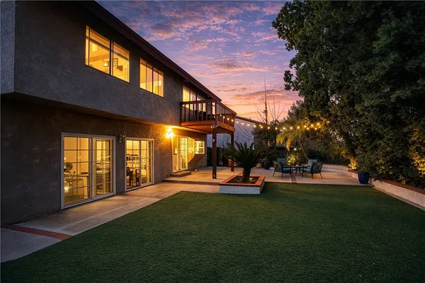a view of a house with a swimming pool and sitting area