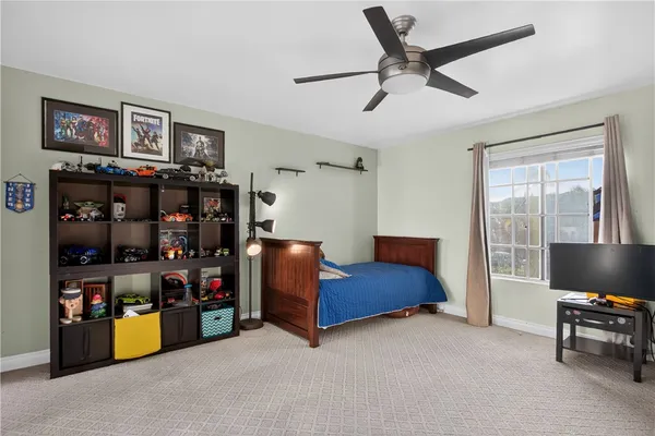 a bedroom with bed and a book shelf