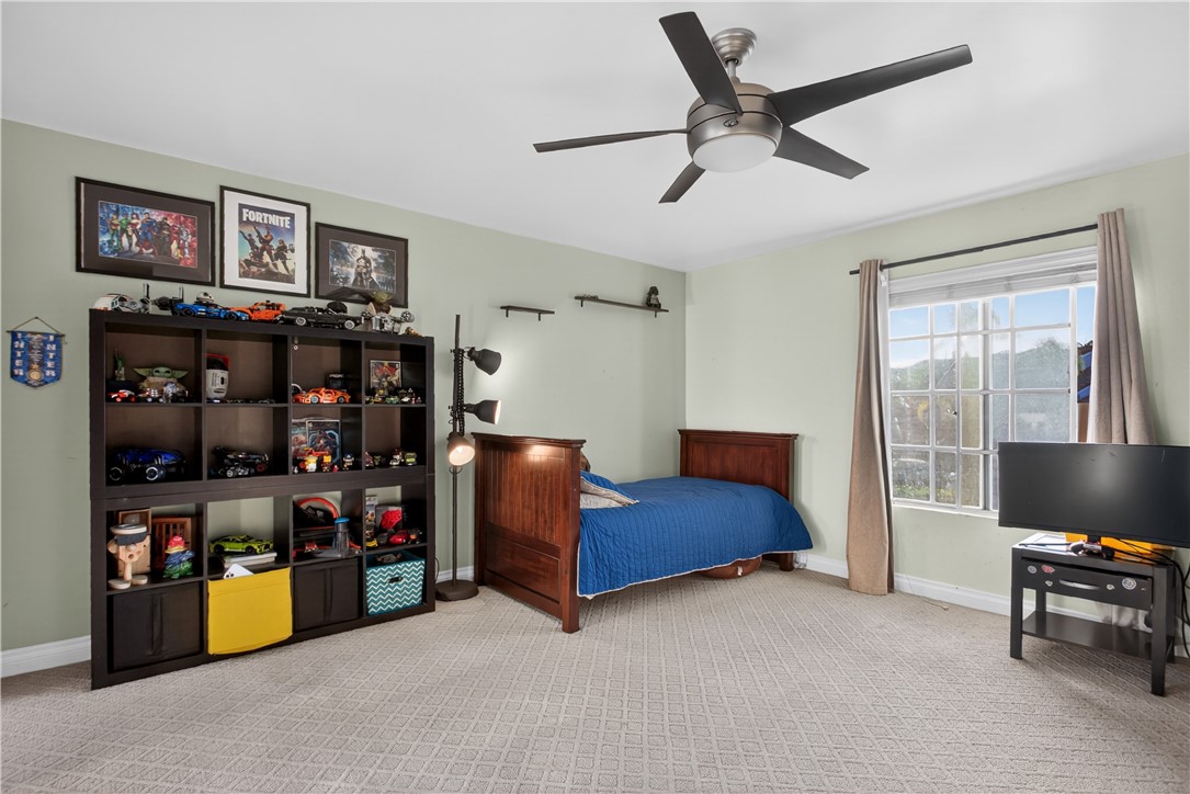 720 Ridgeview Road Anaheim Hills, CA 92807 - Photo 27 of 36 a bedroom with bed and a book shelf