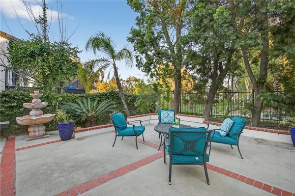 a view of a backyard with furniture and a fire pit