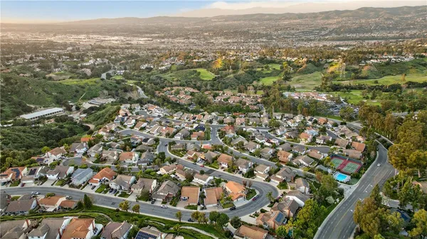 an aerial view of residential houses with city view