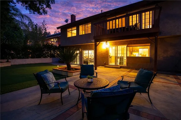 a view of a patio with table and chairs with wooden floor and fence