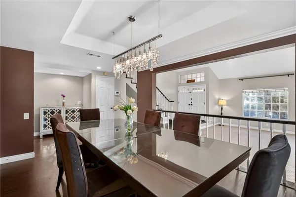 a view of a dining room with furniture and wooden floor