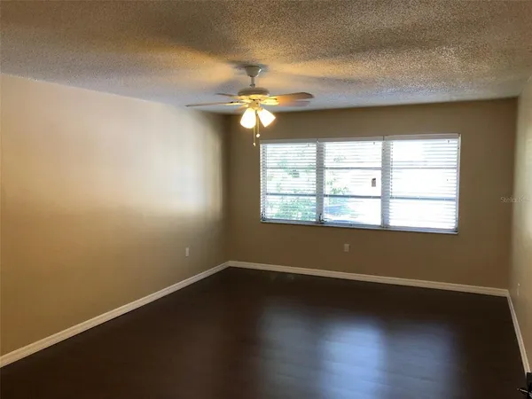 a view of room with window and ceiling fan