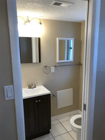 a bathroom with a sink a toilet and mirror