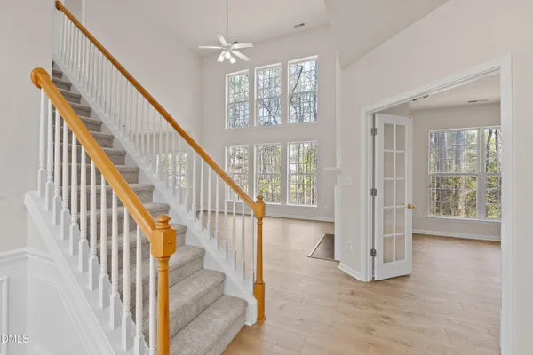 a view of a livingroom with wooden floor and a fireplace