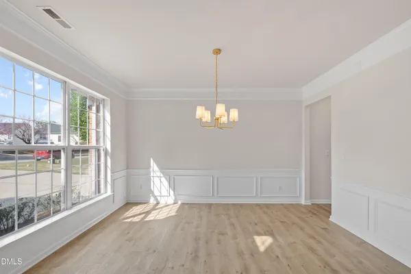 a view of a chandelier in big room and hallway