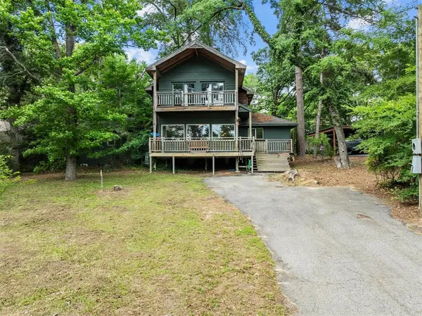 a view of a house with a backyard and balcony