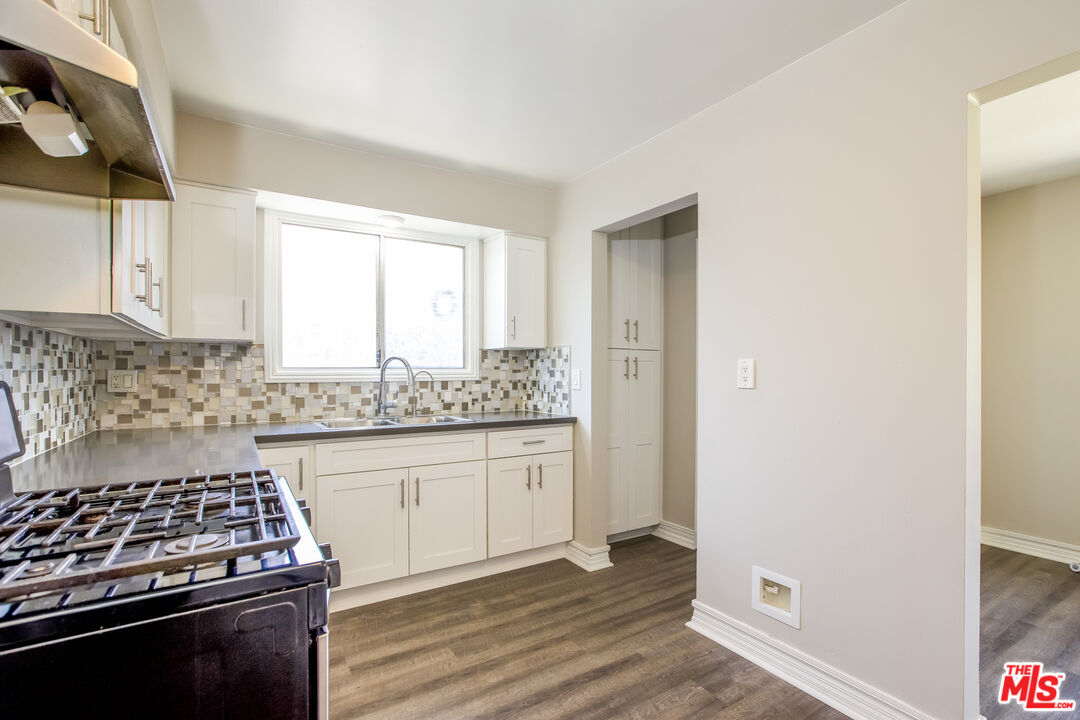 13014 Chestnut Avenue Rancho Cucamonga, CA 91739 - Photo 12 of 25 a kitchen with granite countertop a stove and a sink