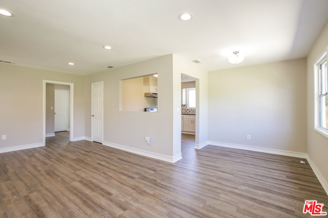 13014 Chestnut Avenue Rancho Cucamonga, CA 91739 - Photo 10 of 25 a view of an empty room with wooden floor and a window